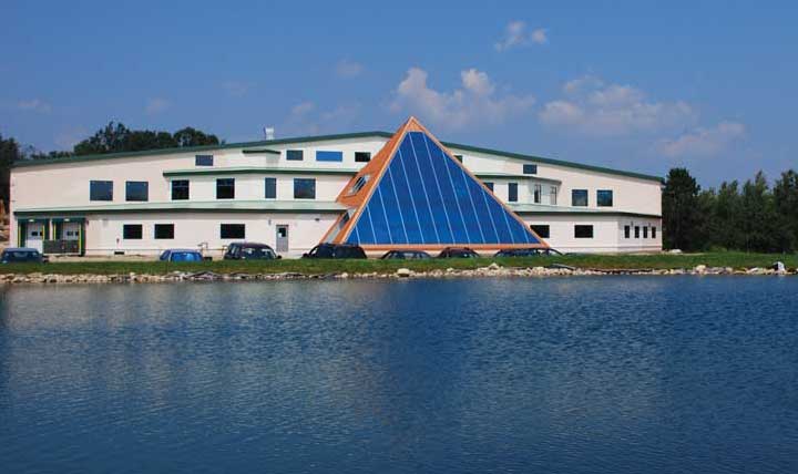 A great view of the front face of our new Beltane Hill facility as it reflects off 
of our beloved swimming hole.